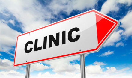 Arrow sign with a blue sky backgroundthat says Clinic - Business Protection Specialists