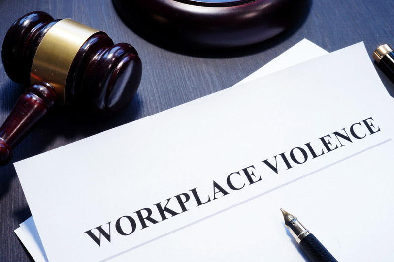 A gavel, fountain pen and paper that says Workplace Violence - Business Protection Specialists