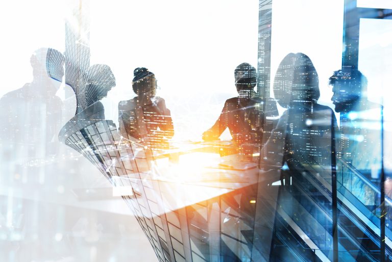 Double exposure of a business meeting and city skyline, symbolizing corporate strategy and urban growth in a modern environment.