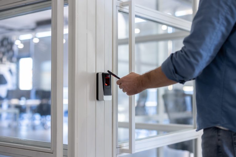 Person using security card to gain access into an office building.